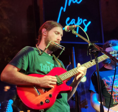 Man in green shirt playing guitar