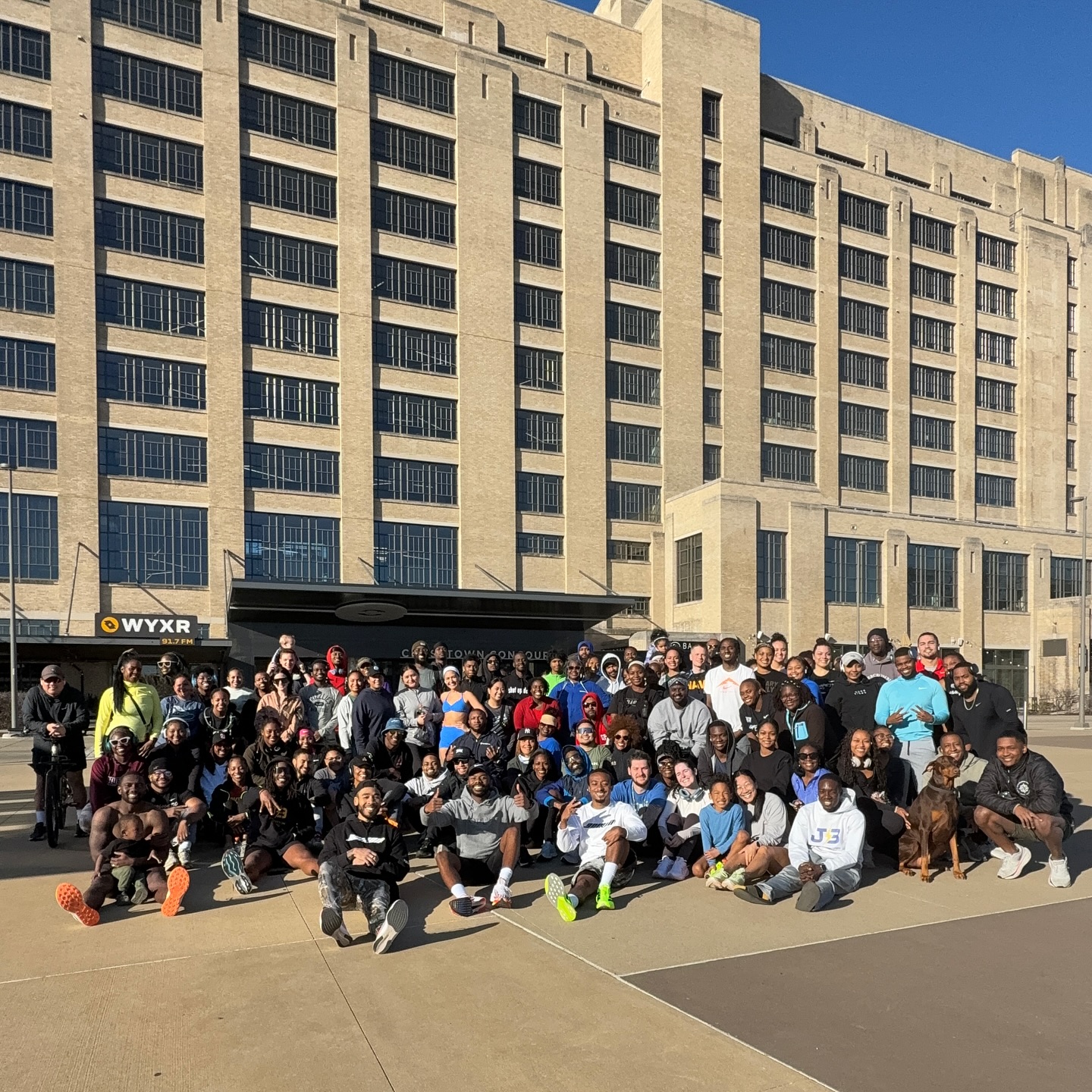 A large group of people gathered outside Crosstown Concourse