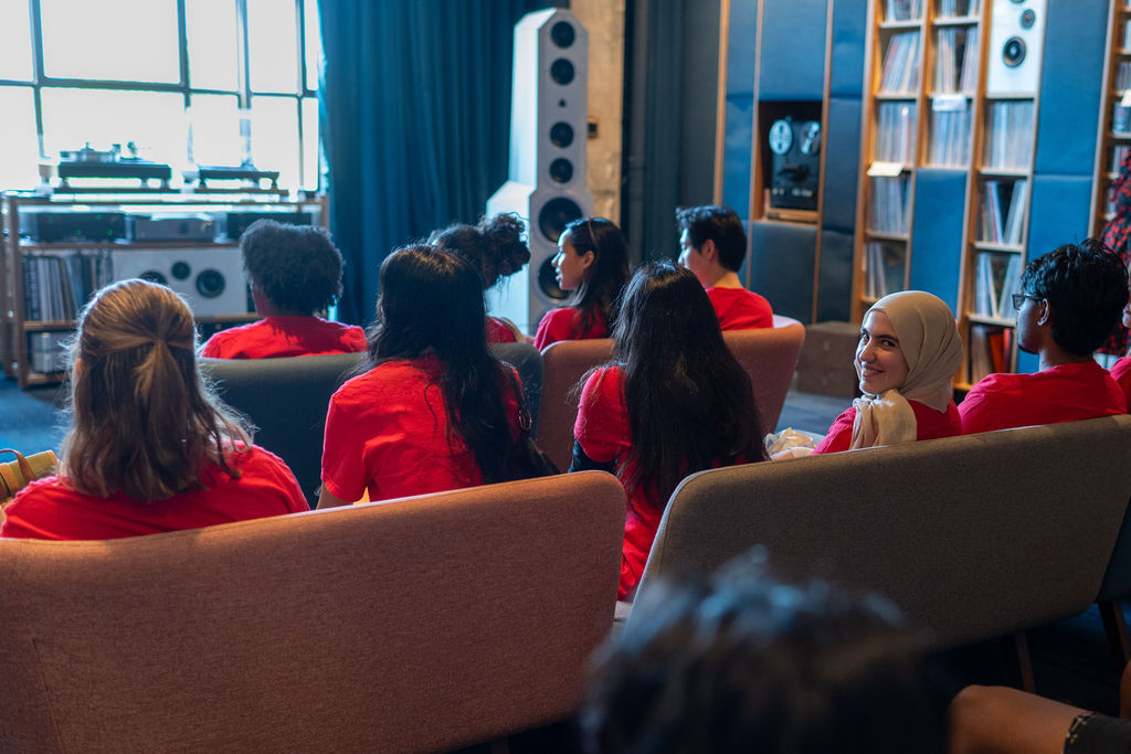 A group of students sit in the listening room in Memphis Listening Lab