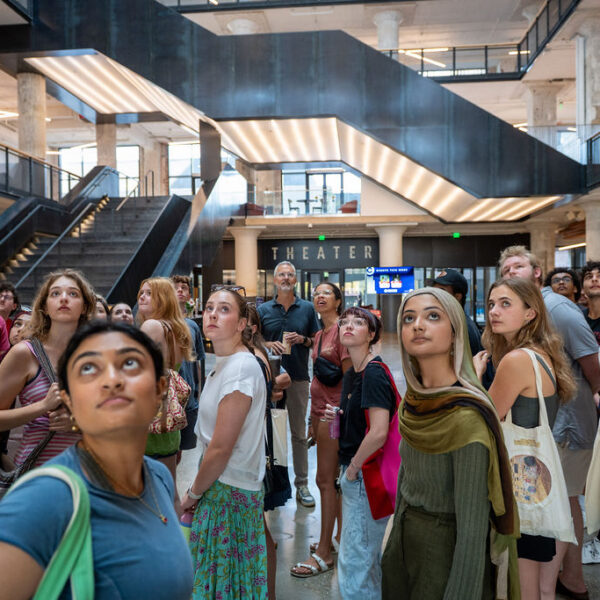 a group of students looking up in the central atrium of Crosstown Concourse