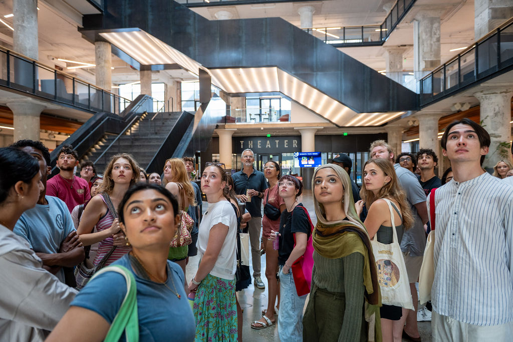 a group of students looking up in the central atrium of Crosstown Concourse