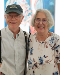 Barbara Penn standing next to a man and smiling.