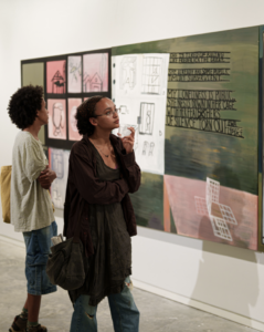 Two people looking at art.